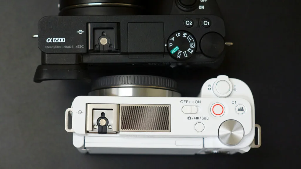 Top view comparison of Sony a6500 and ZV-E10 cameras, highlighting their different control layouts.