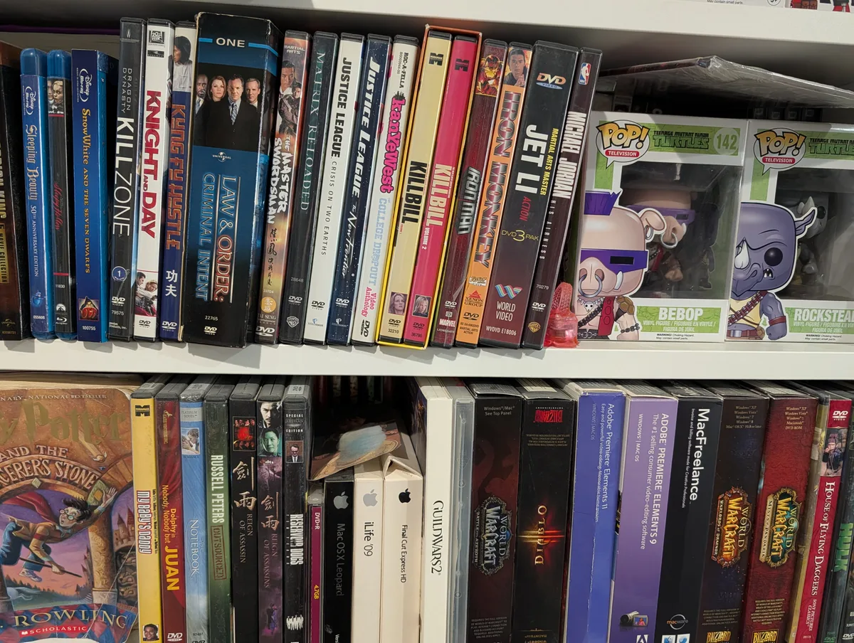 Shelves packed with DVDs, Blu-rays, software boxes, and Funko Pop figures of Bebop and Rocksteady.
